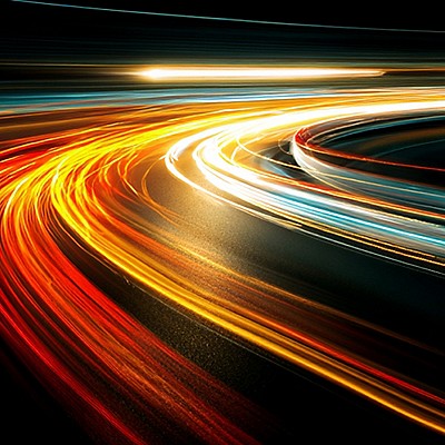 A dynamic image of vibrant light trails in red, yellow, and white curving across a dark background, conveying a sense of speed and motion.