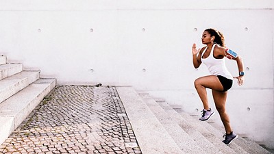 A woman runs up stairs working on her fitness