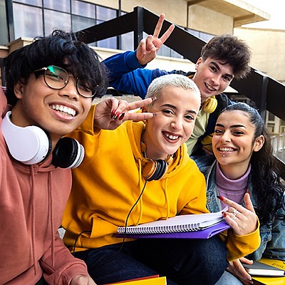 Students smiling together with study materials.