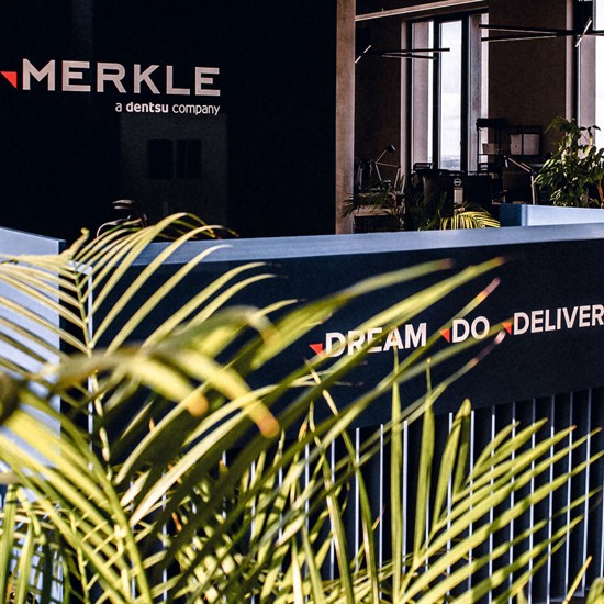 Merkle's front desk with a beautiful plant next to it