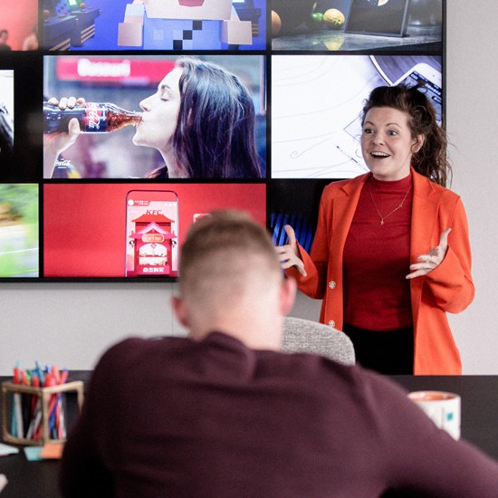 A woman presenting to a group of people at Merkle
