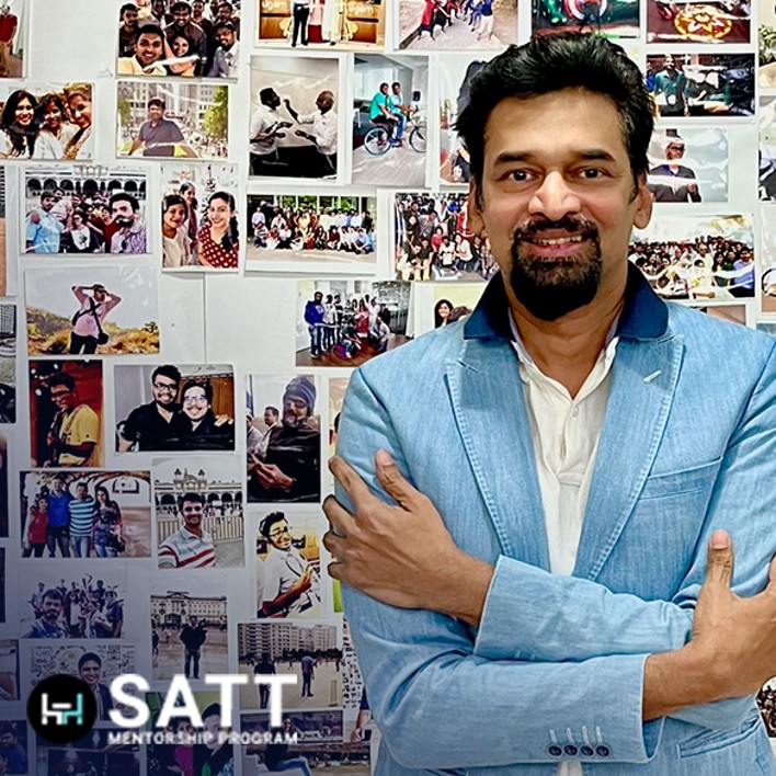 man in front of photos