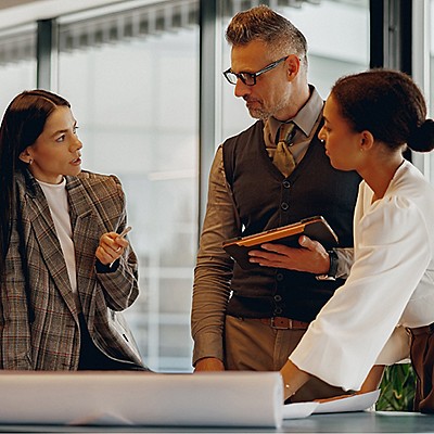 Business team reviewing project details in office.