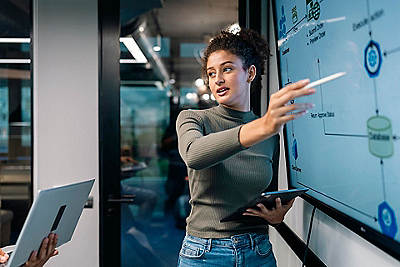 woman presenting with tablet in hand