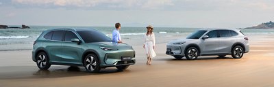 Two people with two cars on a beach