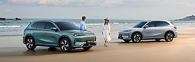 Two people with two cars on a beach