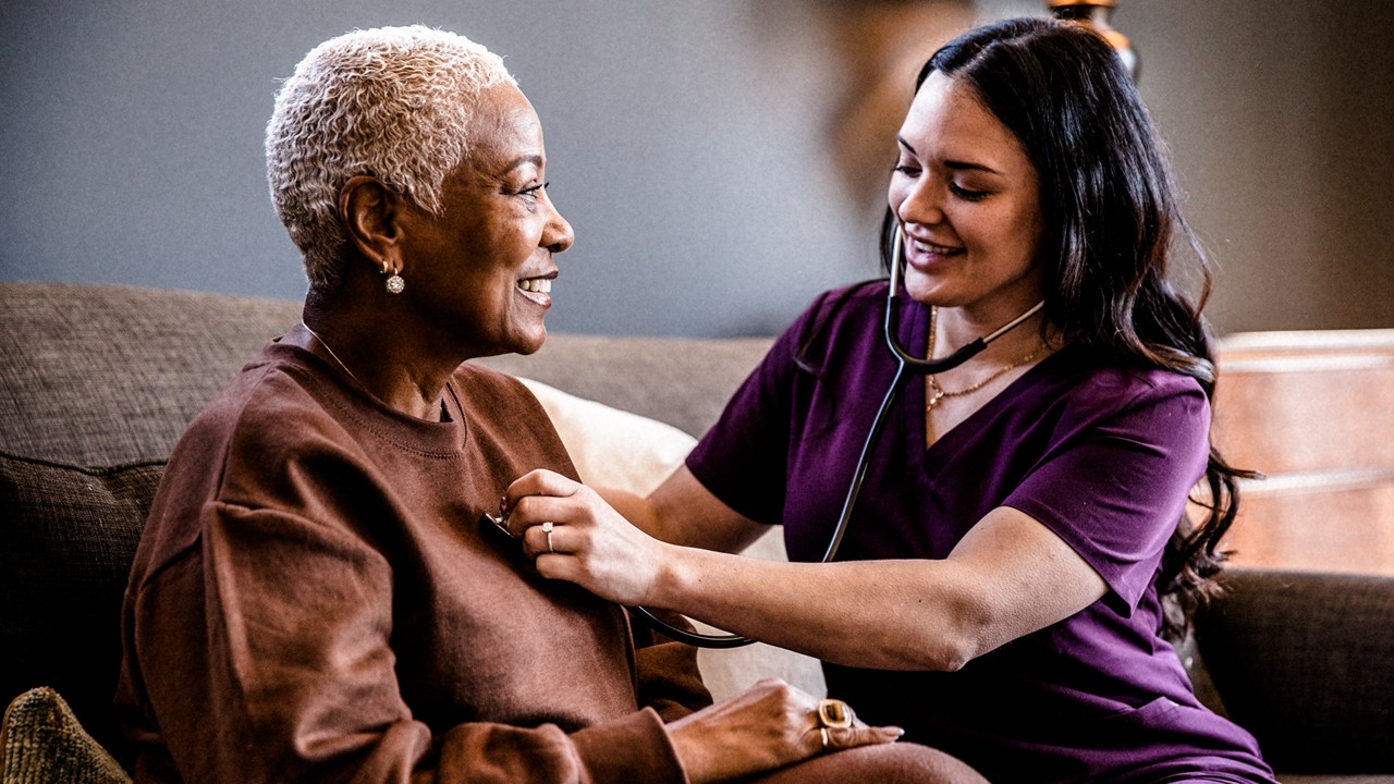 Nurse checking heart of patient
