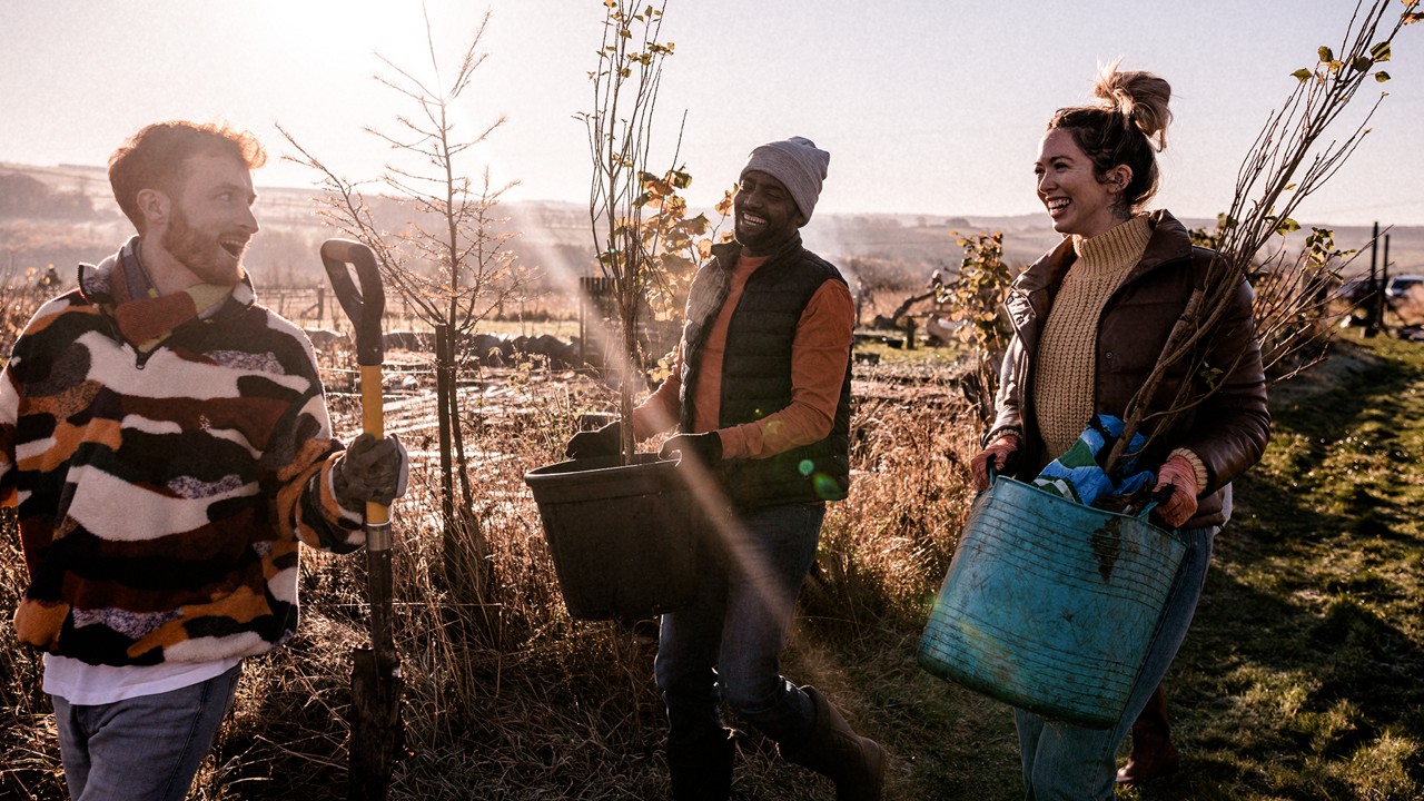 Three people working outdoors