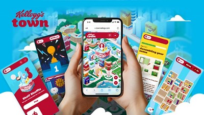 Hands holding a smartphone displaying a colorful, virtual Kellogg's town.
