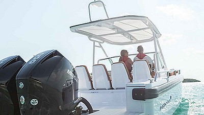 A couple drives their fishing boat in the ocean