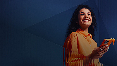 woman smiling holding cell phone