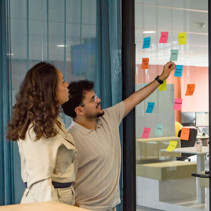 Two colleagues in a brainstorm session with post its