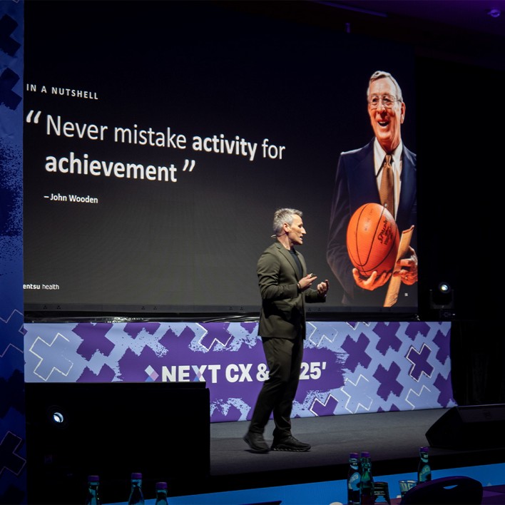 man speaking at a conference