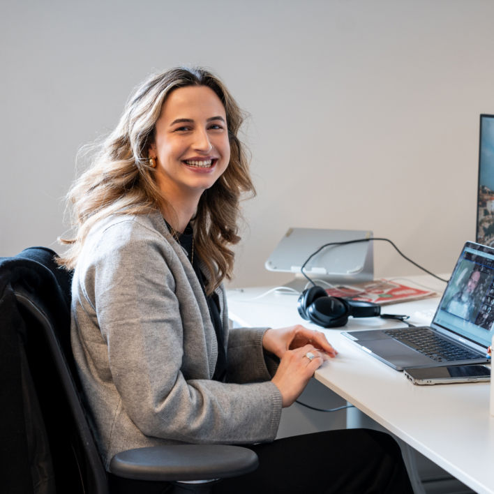 Colleagues working at a laptop and smiling