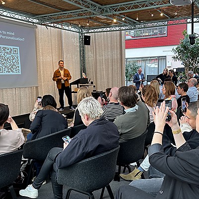 Personalisation event with a person presenting and an audience