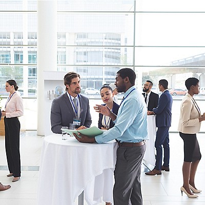 A group of 3 people discussing over a round table