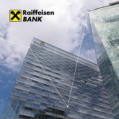 Modern glass buildings of Raiffeisen Bank are set against a cloudy sky, with the bank's logo prominently displayed.