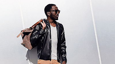 Man wearing sunglasses holding a bag