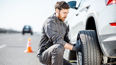 Man changing tire on a car