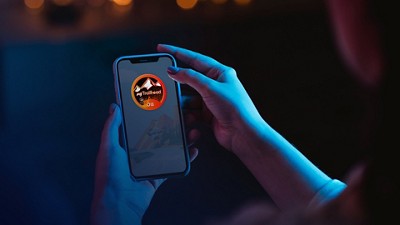 A person holds a mobile phone in their hand