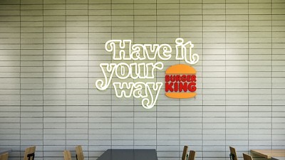 Neon have it your way sign with burger king logo hanging on a wall