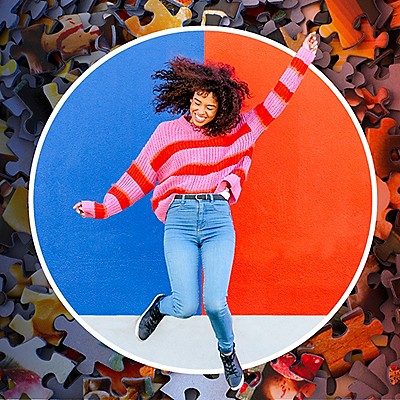 Girl jumping with a colorful wall behind her