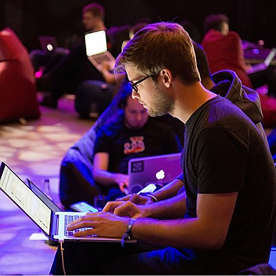 A group of people working on their laptops