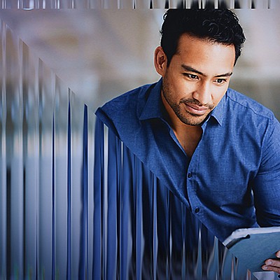 A young man looking at the tablet screen