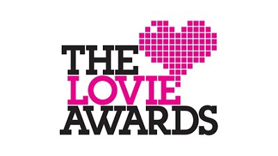 Logo for The Lovie Awards featuring a pixelated heart and bold text in pink and black, celebrating digital excellence.
