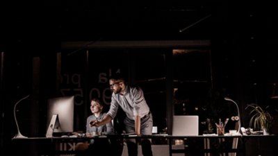 Man guiding women working on the laptop